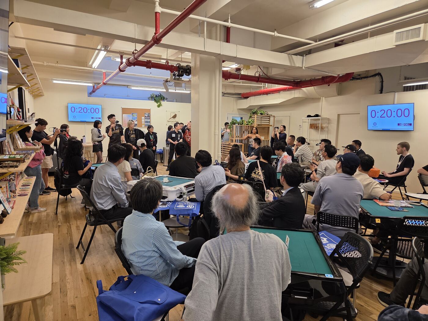 A full house watching tournament play under the match timers